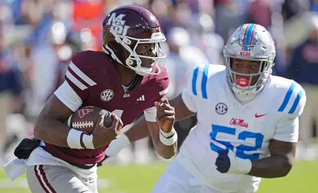 Mississippi State quarterback Kamario Taylor (1) is pursued by Mississippi defensive tackle Will Echoles (52) during the first half of an NCAA college football game Frifday, Nov. 28, 2025, in Starkville, Miss. (AP Photo/Rogelio V. Solis)
