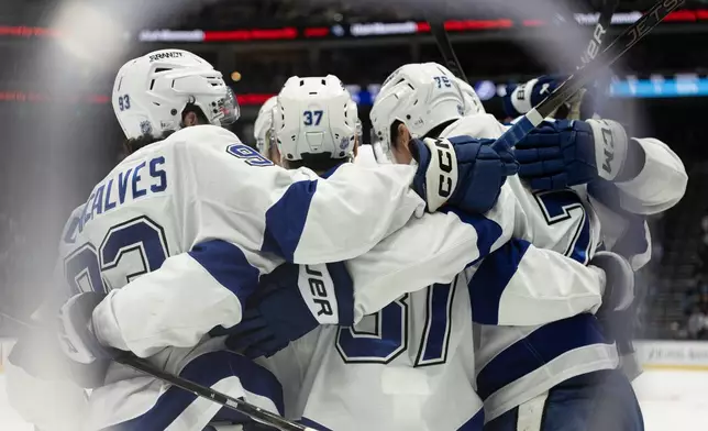 Tampa Bay Lightning players celebrate after a goal against the Utah Mammoth during the first period of an NHL hockey game Sunday, Nov. 2, 2025, in Salt Lake City. (AP Photo/Melissa Majchrzak)
