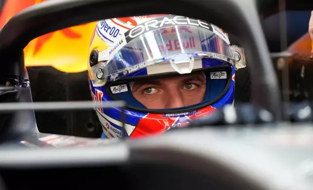 Red Bull driver Max Verstappen of the Netherlands watches from his car during the first qualifying session at the Lusail International Circuit ahead of the Qatar Formula One Grand Prix, in Lusail, Qatar, Friday, Nov. 28, 2025. (AP Photo/Darko Bandic)