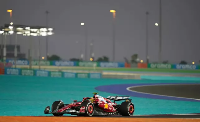 Ferrari driver Lewis Hamilton of Britain steers his car during the first qualifying session at the Lusail International Circuit ahead of the Qatar Formula One Grand Prix, in Lusail, Qatar, Friday, Nov. 28, 2025. (AP Photo/Altaf Qadri)