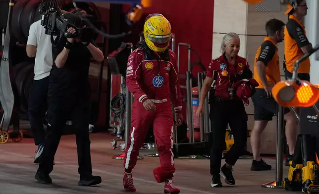 Ferrari driver Lewis Hamilton of Britain walks through the pit lame during the sprint qualifying for the Formula One Qatar Grand Prix in Friday, Nov. 28, 2025. (AP Photo/Altaf Qadri, Pool)
