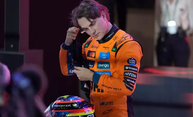 McLaren driver Oscar Piastri of Australia gestures after setting the pole position in the sprint qualifying at the Lusail International Circuit ahead of the Qatar Formula One Grand Prix, in Lusail, Qatar, Friday, Nov. 28, 2025. (AP Photo/Altaf Qadri)