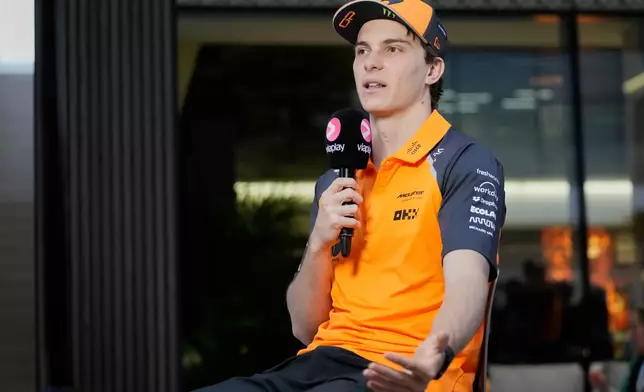 McLaren driver Oscar Piastri of Australia talks to the media at the Lusail International Circuit ahead of the Qatar Formula One Grand Prix, in Lusail, Qatar, Thursday, Nov. 27, 2025. (AP Photo/Darko Bandic)