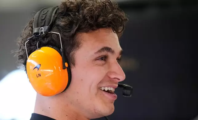 McLaren driver Lando Norris of Britain smiles at pits during the first qualifying session at the Lusail International Circuit ahead of the Qatar Formula One Grand Prix, in Lusail, Qatar, Friday, Nov. 28, 2025. (AP Photo/Darko Bandic)