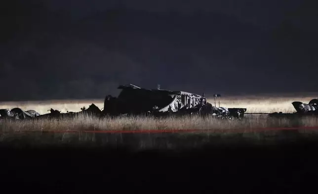 Debris is seen at a crash site of a Turkish military cargo plane in Georgia's Sighnaghi municipality, close to the Azerbaijani border on Wednesday, Nov. 12, 2025. (AP Photo/Zurab Tsertsvadze)
