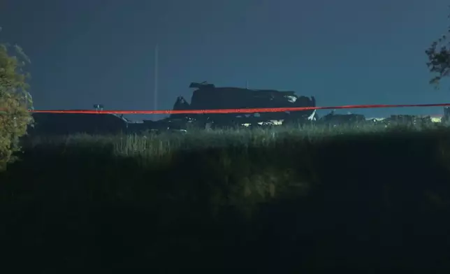 Debris is seen at a crash site of a Turkish military cargo plane in Georgia's Sighnaghi municipality, close to the Azerbaijani border on Wednesday, Nov. 12, 2025. (AP Photo/Zurab Tsertsvadze)