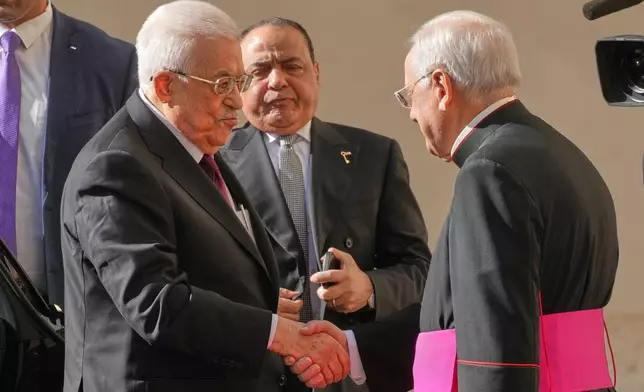 Palestinian President Mahmoud Abbas, also known as Abu Mazen, left, is welcomed by Monsignor Leonardo Sapienza as he arrives in the St. Damasus Courtyard at the Vatican for a meeting with Pope Leo XIV, Thursday, Nov. 6, 2025. (AP Photo/Andrew Medichini)