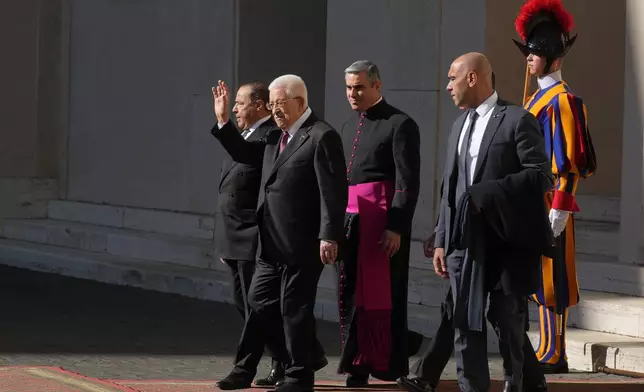 Palestinian President Mahmoud Abbas, also known as Abu Mazen,, left, waves as he leaves the St. Damasus Courtyard at the Vatican after meeting with Pope Leo XIV, Thursday, Nov. 6, 2025. (AP Photo/Andrew Medichini)