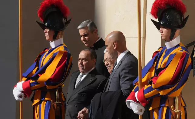 Palestinian President Mahmoud Abbas, also known as Abu Mazen, center, leaves the St. Damasus Courtyard at the Vatican after meeting with Pope Leo XIV, Thursday, Nov. 6, 2025. (AP Photo/Andrew Medichini)