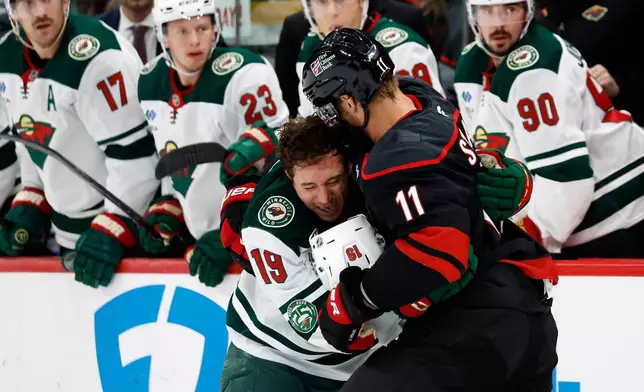 Carolina Hurricanes' Jordan Staal (11) exchanges blows with Minnesota Wild's Tyler Pitlick (19) during the first period of an NHL hockey game in Raleigh, N.C., Thursday, Nov. 6, 2025. (AP Photo/Karl DeBlaker)