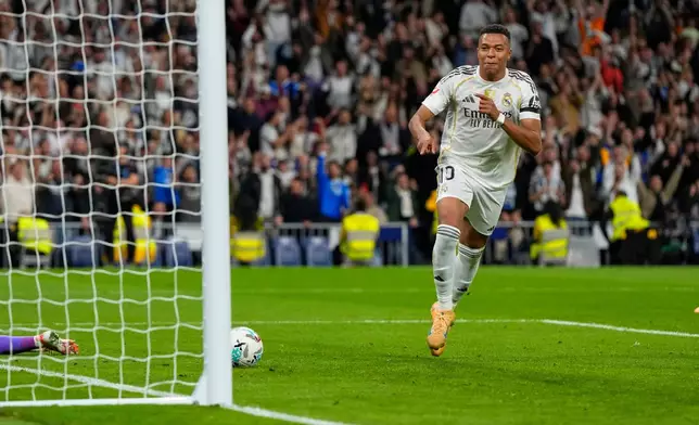 Real Madrid's Kylian Mbappe celebrates after scoring his side's second goal during the Spanish La Liga soccer match between Real Madrid and Valencia in Madrid, Spain, Saturday, Nov. 1, 2025. (AP Photo/Manu Fernandez)
