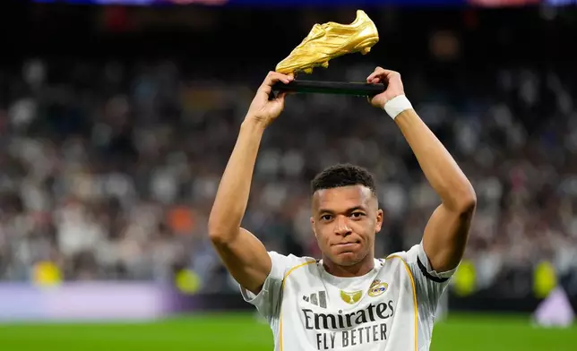 Real Madrid's Kylian Mbappe poses with the Golden Boot award before the Spanish La Liga soccer match between Real Madrid and Valencia in Madrid, Spain, Saturday, Nov. 1, 2025. (AP Photo/Manu Fernandez)