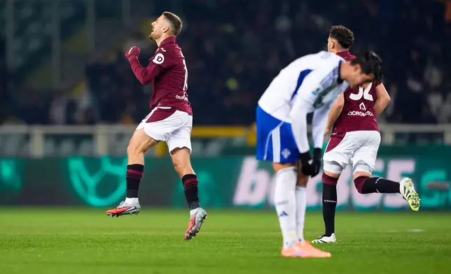 Torino's Nikola Vlasic celebrates after scoring during the Serie A soccer match between Torino and Como, in Turin, Italy, Monday, Nov. 24, 2025. (Fabio Ferrari/LaPresse via AP)