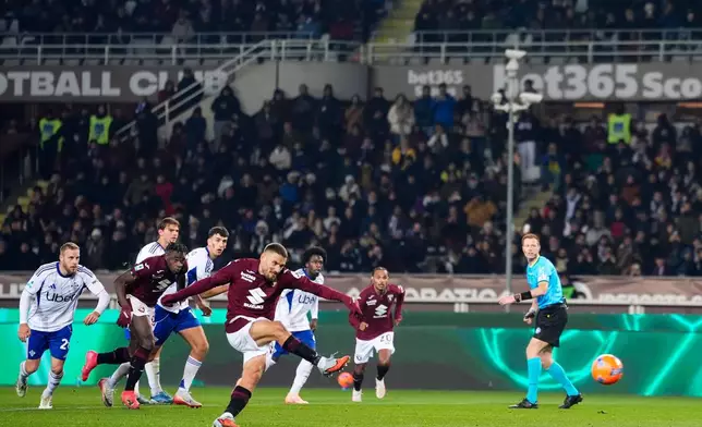 Torino's Nikola Vlasic scores during the Serie A soccer match between Torino and Como, in Turin, Italy, Monday, Nov. 24, 2025. (Fabio Ferrari/LaPresse via AP)