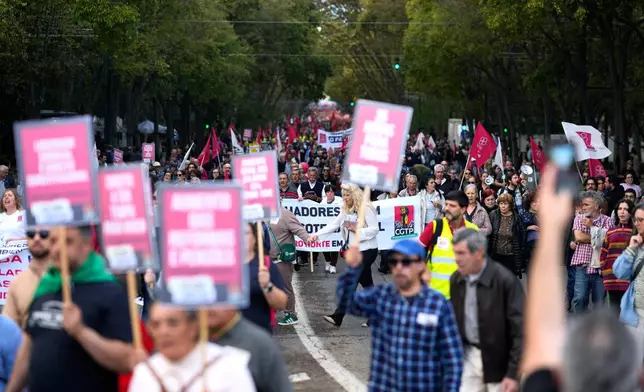 Demonstrators march down Liberdade Avenue during a national protest by workers unions against a new labour package being prepared by the government, in Lisbon, Portugal, Saturday, Nov. 8, 2025. (AP Photo/Armando Franca)