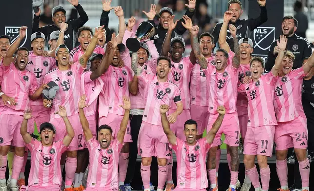 Inter Miami forward Lionel Messi (10) lifts the trophy as Inter Miami players celebrate winning an MLS Eastern Conference final soccer match against New York City FC, Saturday, Nov. 29, 2025, in Fort Lauderdale, Fla. (AP Photo/Rebecca Blackwell)
