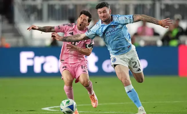 Inter Miami forward Lionel Messi (10) clashes with New York City FC midfielder Aiden O'Neill (21) during the first half of an MLS Eastern Conference final soccer match, Saturday, Nov. 29, 2025, in Fort Lauderdale, Fla. (AP Photo/Rebecca Blackwell)