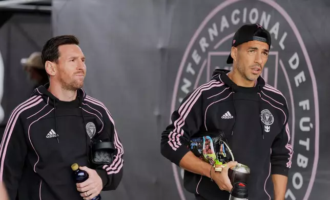 Inter Miami forwards Lionel Messi, left, and Luis Suarez arrive for an MLS Eastern Conference final soccer match against New York FC, Saturday, Nov. 29, 2025, in Fort Lauderdale, Fla. (AP Photo/Rebecca Blackwell)