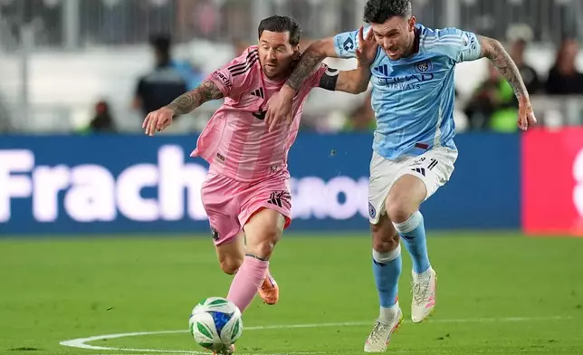 Inter Miami forward Lionel Messi, left,clashes with New York City FC midfielder Aiden O'Neill, right, during the first half of an MLS Eastern Conference final soccer match, Saturday, Nov. 29, 2025, in Fort Lauderdale, Fla. (AP Photo/Rebecca Blackwell)