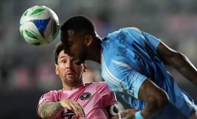 Inter Miami forward Lionel Messi (10) gets beat out for a header by New York City FC defender Raul Gustavo during the first half of an MLS Eastern Conference final soccer match, Saturday, Nov. 29, 2025, in Fort Lauderdale, Fla. (AP Photo/Rebecca Blackwell)