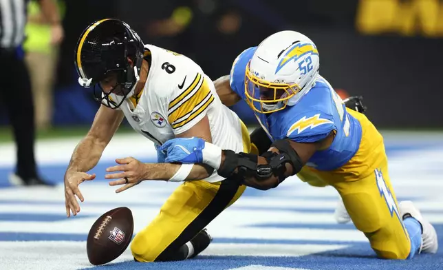 Los Angeles Chargers linebacker Khalil Mack (52) forces Pittsburgh Steelers quarterback Aaron Rodgers (8) to fumble during the first half of an NFL football game Sunday, Nov. 9, 2025, in Inglewood, Calif. (AP Photo/Jessie Alcheh)