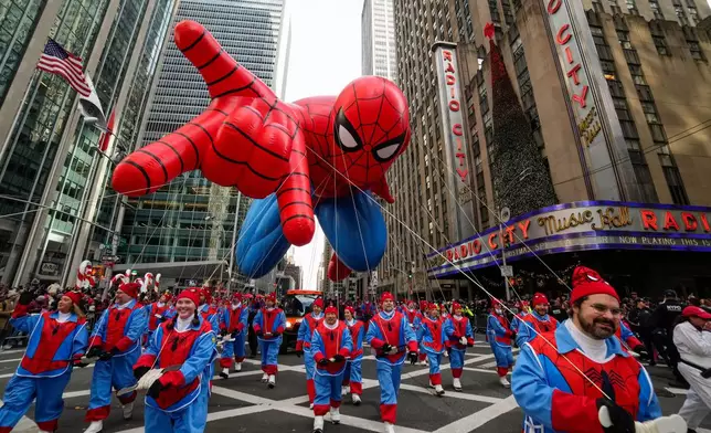 Balloon handlers guide the Spider Man balloon past Radio City Music Hall during the Macy's Thanksgiving Day Parade, Thursday, Nov. 27, 2025, in New York. (AP Photo/Eduardo Munoz Alvarez)