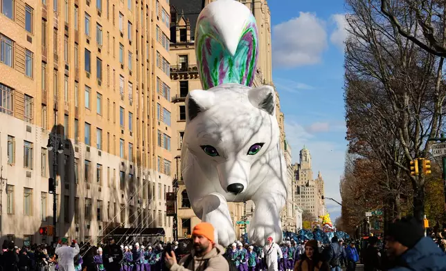 Balloon handlers guide the Noorah balloon down Central Park West during the Macy's Thanksgiving Day Parade, Thursday, Nov. 27, 2025, in New York. (AP Photo/Frank Franklin)