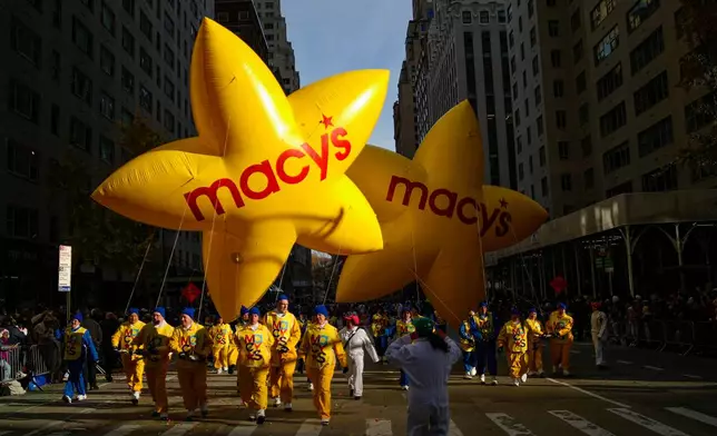 Balloon handlers guide the Macy's balloons down Sixth Avenue during the Macy's Thanksgiving Day Parade, Thursday, Nov. 27, 2025, in New York. (AP Photo/Eduardo Munoz Alvarez)