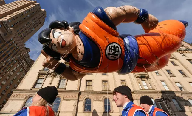 Balloon handlers guide the Goku balloon down Central Park West during the Macy's Thanksgiving Day Parade, Thursday, Nov. 27, 2025, in New York. (AP Photo/Frank Franklin II)