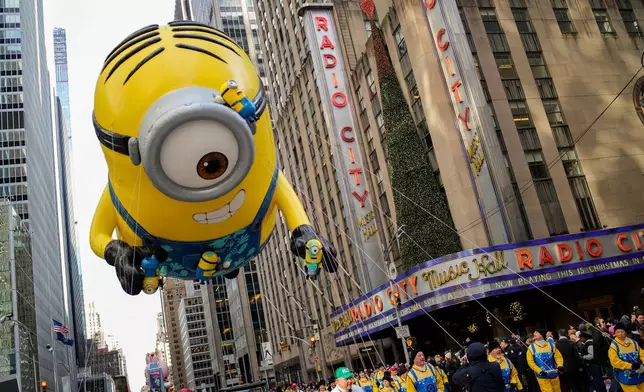 The Stuart the Minion balloon floats past Radio City Music Hall during the Macy's Thanksgiving Day Parade, Thursday, Nov. 27, 2025, in New York. (AP Photo/Eduardo Munoz Alvarez)