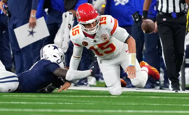Dallas Cowboys linebacker DeMarvion Overshown, left, knocks the ball out of bounds away from Kansas City Chiefs quarterback Patrick Mahomes during the first half of an NFL football game Thursday, Nov. 27, 2025, in Arlington, Texas. (AP Photo/Tony Gutierrez)