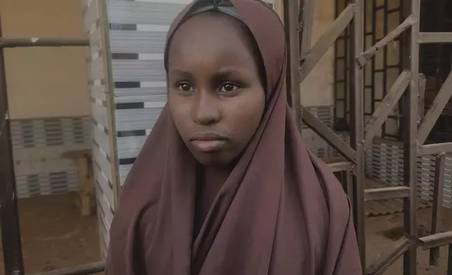Hawau Usman, a 15 year-old student who was kidnapped by gunmen Monday from the Government Girls Comprehensive Secondary School and managed to escape, is interviewed, in Kebbi, Nigeria, Tuesday, Nov. 18, 2025. (AP Photo/Tunde Omolehin)