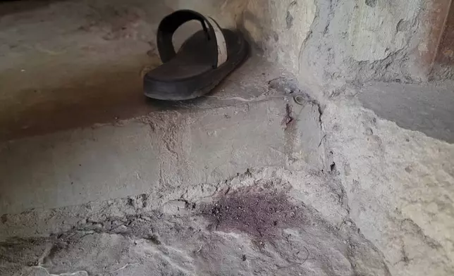 A stain of blood is seen on the ground of the Government Girls Comprehensive Secondary School, where gunmen on Monday attacked the school dormitory, abducted schoolgirls, and killed Hassan Yakubu Makuku, vice principal of the school, in Kebbi, Nigeria, Tuesday, Nov. 18, 2025. (AP Photo/Tunde Omolehin)