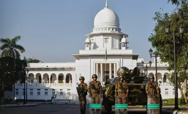 Bangladeshi Army soldiers stand guard outside the Supreme Court after security have been beefed up across the country ahead of an expected verdict against ousted Prime Minister Sheikh Hasina, in Dhaka, Bangladesh, Monday, Nov. 17, 2025. (AP Photo/Rajib Dhar)