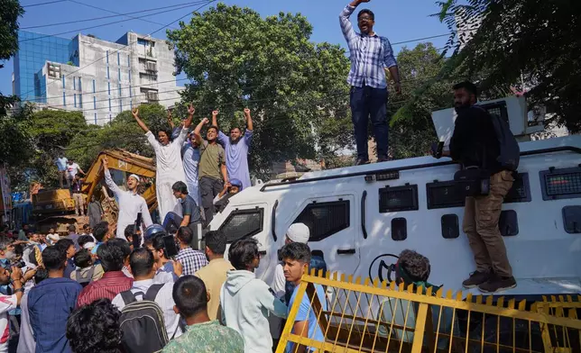Protesters shout slogans outside the demolished residence of Sheikh Mujibur Rahman, Bangladesh's former leader and the father of the country's ousted Prime Minister Sheikh Hasina ahead of an expected verdict against Hasina, in Dhaka, Bangladesh, Monday, Nov. 17, 2025. (AP Photo/ Ahadul Karim Khan)