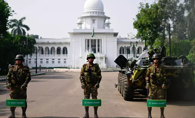 Security personnel stand guard at Bangladesh's Supreme Court as ousted Prime Minister Sheikh Hasina and her former ruling Awami League party called for a nationwide "lockdown" in protest against her trial in Dhaka, Bangladesh, Thursday, Nov. 13, 2025. (AP Photo/Mahmud Hossain Opu)