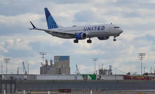 A plane lands at Newark International Airport in Newark, N.J., Thursday, Nov. 6, 2025. (AP Photo/Seth Wenig)