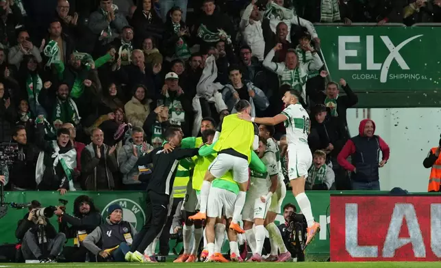 Elche's team players celebrate after Aleix Febas scored the opening goal during the Spanish La Liga soccer match between Elche and Real Madrid in Elche, Spain, Sunday, Nov. 23, 2025. (AP Photo/Alberto Saiz)