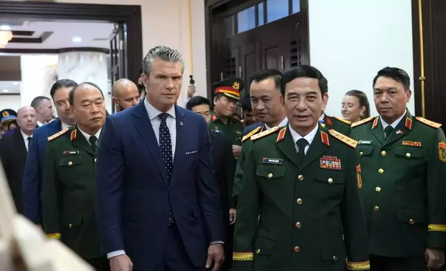 U.S. Defense Secretary Pete Hegseth and Vietnamese Defense Minister Phan Van Giang walk to a meeting in Hanoi, Vietnam, Sunday, Nov. 2, 2025. (AP Photo/Hau Dinh)