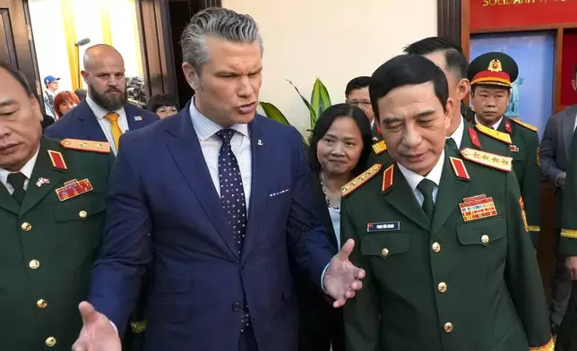 U.S. Defense Secretary Pete Hegseth speaks to Vietnamese Defense Minister Phan Van Giang before a meeting in Hanoi, Vietnam, Sunday, Nov. 2, 2025. (AP Photo/Hau Dinh)