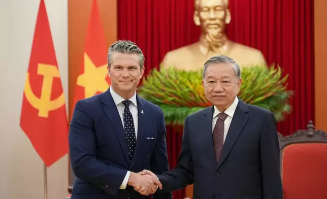 U.S. Defense Secretary Pete Hegseth and General Secretary of Vietnam's Communist Party To Lam shake hands in Hanoi, Vietnam, Sunday, Nov. 2, 2025. (AP Photo/Hau Dinh)