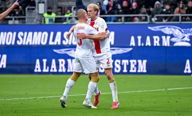 Genoa's Leo Skiri Ostigard, left, celebrates after scoring during the Serie A soccer match between Cagliari Calcio and Genoa in Cagliari, Sardinia, Italy, Saturday, Nov. 22, 2025. (Gianluca Zuddas/LaPresse via AP)