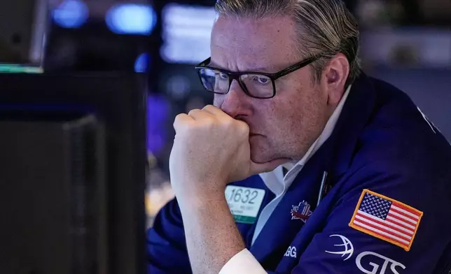 Specialist Gregg Maloney works on the floor of the New York Stock Exchange, Wednesday, Nov. 12, 2025. (AP Photo/Richard Drew)
