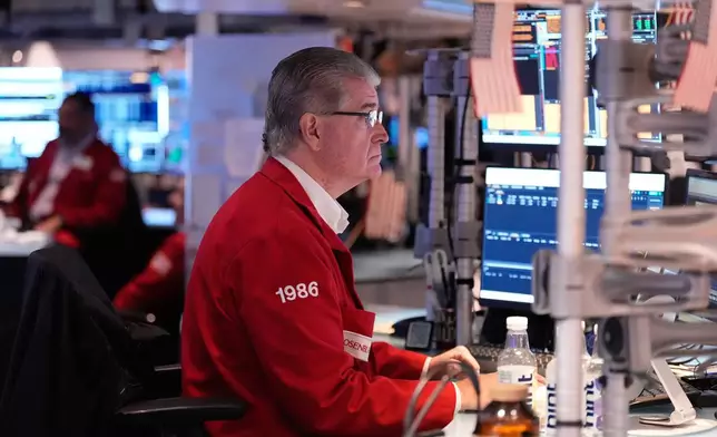 Daniel Kryger works on the floor at the New York Stock Exchange in New York, Thursday, Nov. 13, 2025. (AP Photo/Seth Wenig)