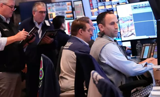 Traders work on the floor at the New York Stock Exchange in New York, Thursday, Nov. 13, 2025. (AP Photo/Seth Wenig)