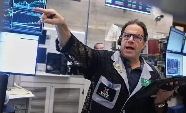 Options trader Anthony Spina works on the floor of the New York Stock Exchange, Wednesday, Nov. 12, 2025. (AP Photo/Richard Drew)