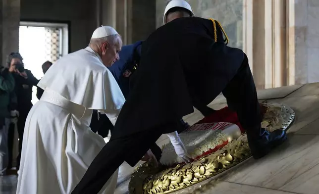 Pope Leo XIV poses a wreath at the Ataturk Mausoleum in Ankara, Turkey, Thursday, Nov. 27, 2025. (AP Photo/Domenico Stinellis)