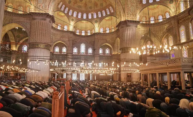 Muslims pray at the Ottoman-era Sultan Ahmed or Blue Mosque, in Istanbul, Turkey, Friday, Nov. 21, 2025, ahead of the visit of Pope Leo XIV to Turkey. (AP Photo/Francisco Seco)