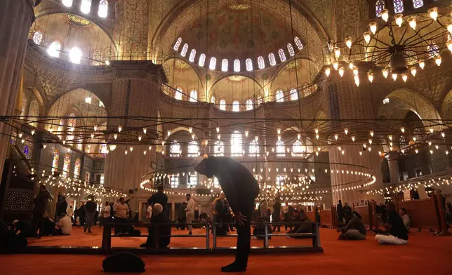 Muslims pray at the Ottoman-era Sultan Ahmed or Blue Mosque, in Istanbul, Turkey, Friday, Nov. 21, 2025, ahead of the visit of Pope Leo XIV to Turkey. (AP Photo/Francisco Seco)