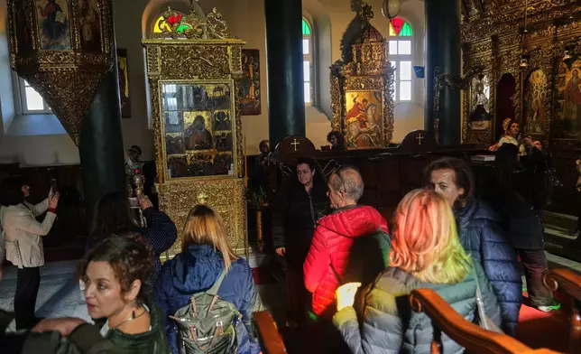 Greek pilgrims visit the church of the Christian Orthodox Holy Trinity monastery, where is also located the Halki Theological school, in Heybeliada island, Istanbul, Turkey, Friday, Nov. 14, 2025. (AP Photo/Francisco Seco)